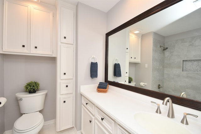 bathroom featuring tile flooring, toilet, and vanity with extensive cabinet space