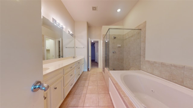 bathroom with tile flooring, separate shower and tub, and dual vanity