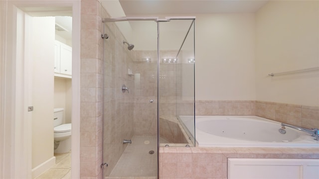 bathroom featuring tile flooring, separate shower and tub, and toilet