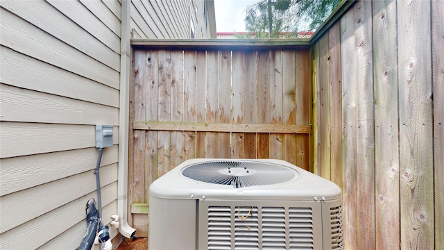 details featuring wood walls and central AC unit