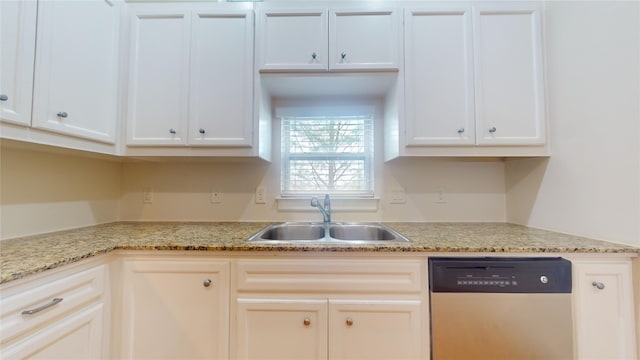 kitchen with white cabinetry, sink, light stone countertops, and stainless steel dishwasher