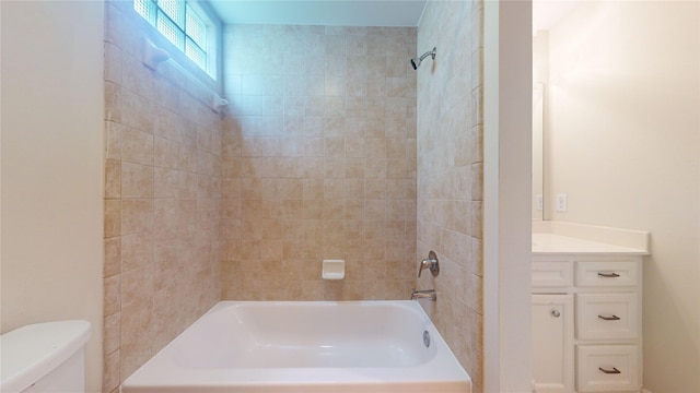 full bathroom with vanity, toilet, and tiled shower / bath combo