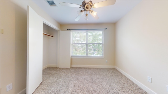 unfurnished bedroom with ceiling fan, a closet, and light carpet