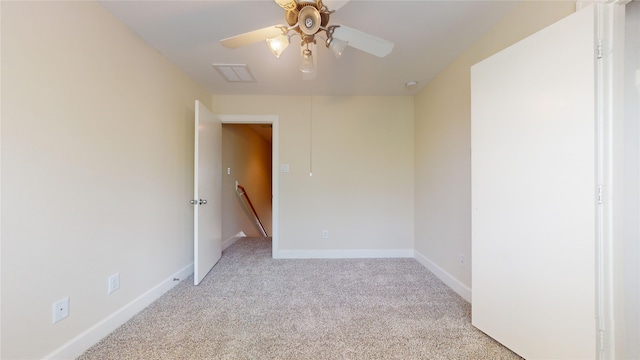 spare room featuring light carpet and ceiling fan