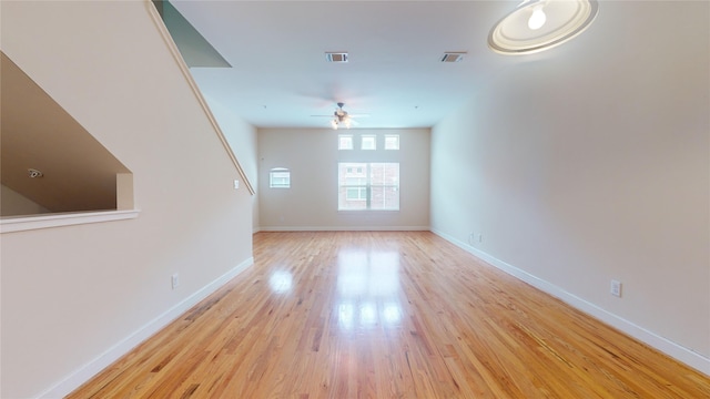 unfurnished living room featuring ceiling fan and light hardwood / wood-style floors