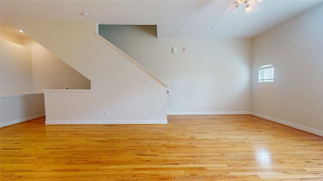 unfurnished living room with light wood-type flooring and ceiling fan