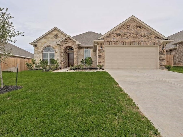 single story home featuring a front lawn and a garage