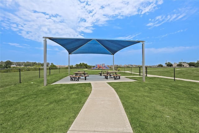 view of property's community with a playground and a yard