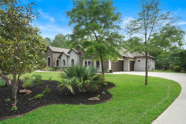 view of front of house with a garage and a front lawn