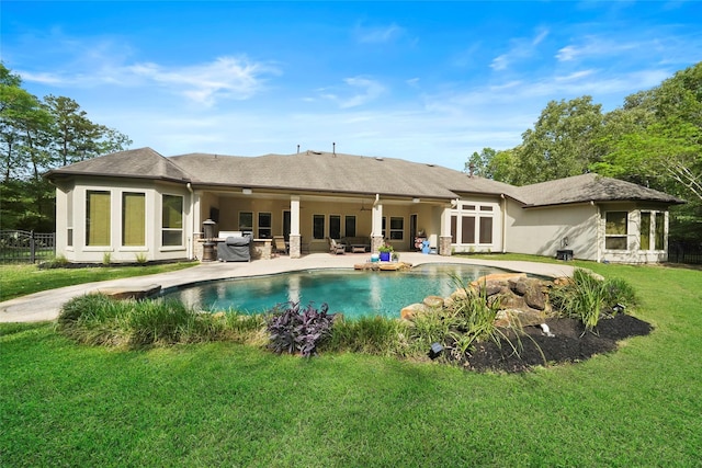 back of property with a patio area, a yard, and an outdoor hangout area