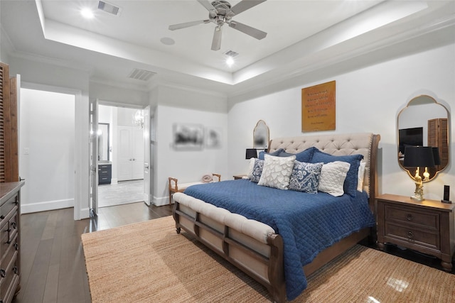 bedroom featuring a raised ceiling, ceiling fan, crown molding, and dark wood-type flooring