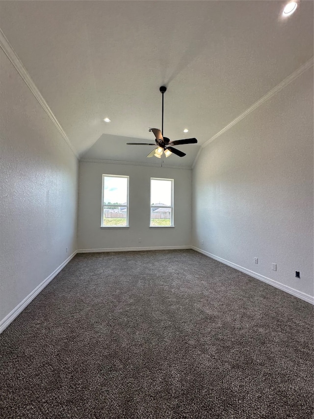 carpeted empty room featuring ceiling fan, vaulted ceiling, and ornamental molding