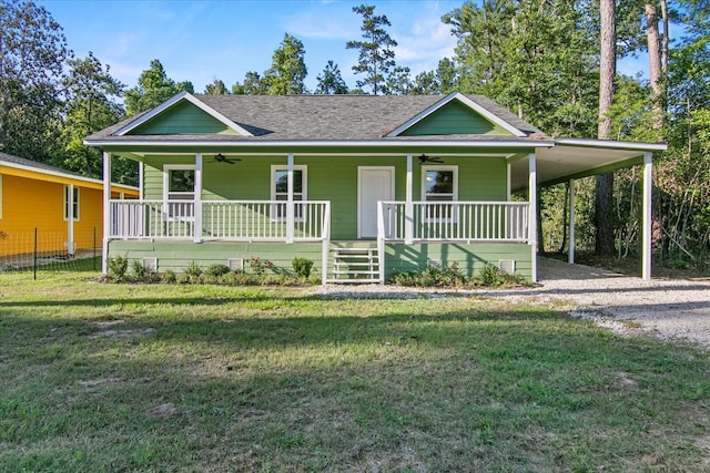 view of front of home featuring covered porch, a carport, and a front yard