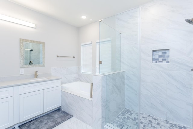 bathroom with shower with separate bathtub, oversized vanity, and tile floors