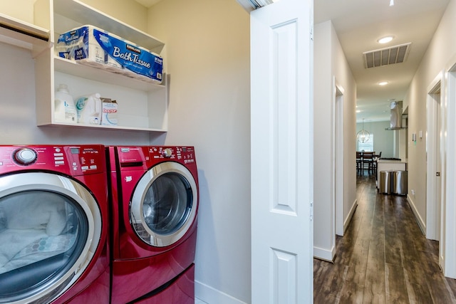 washroom featuring dark hardwood / wood-style floors and washing machine and dryer