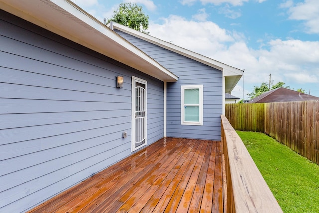 wooden deck featuring a yard