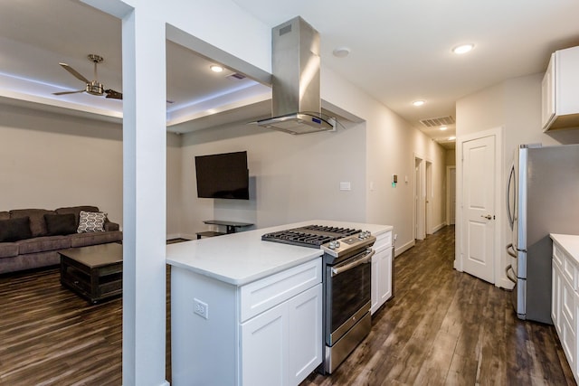 kitchen featuring white cabinetry, island range hood, stainless steel appliances, dark hardwood / wood-style floors, and ceiling fan