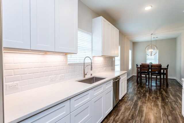 kitchen featuring an inviting chandelier, dark hardwood / wood-style floors, white cabinetry, sink, and pendant lighting