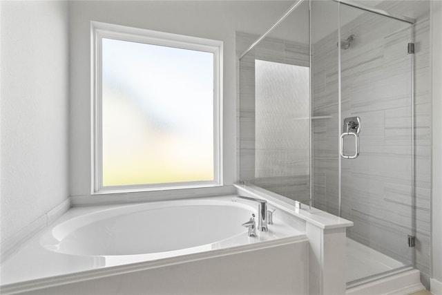 bathroom featuring separate shower and tub