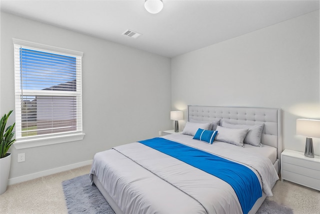 bedroom featuring light carpet and multiple windows