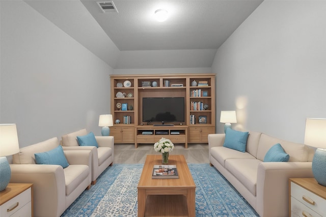 living room featuring lofted ceiling