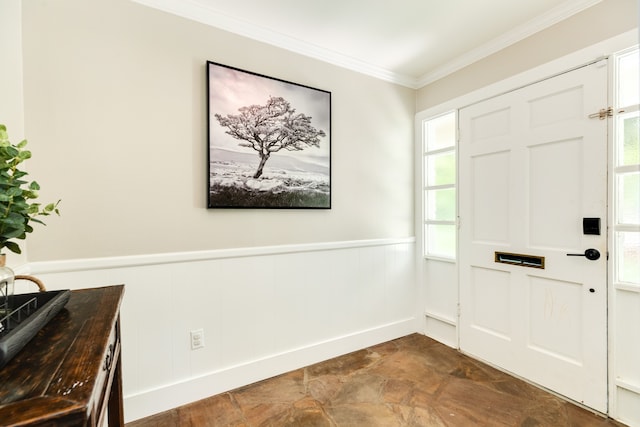 foyer with dark tile flooring and crown molding