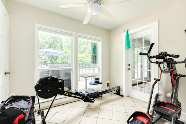 workout room featuring ceiling fan and light tile floors