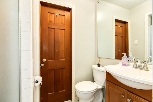 bathroom featuring toilet and vanity