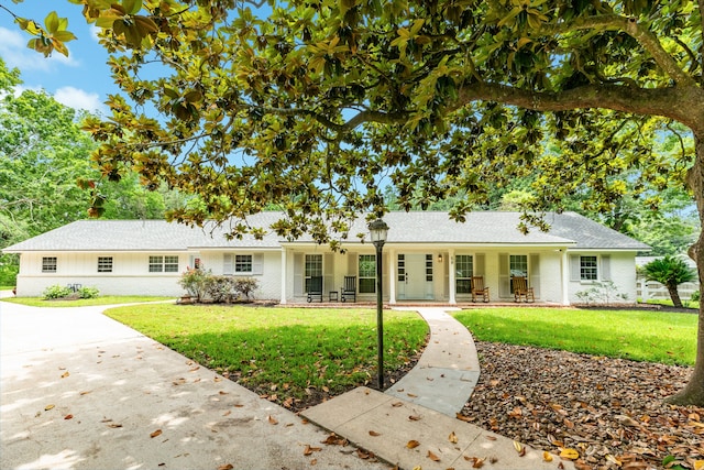 ranch-style home with a front lawn