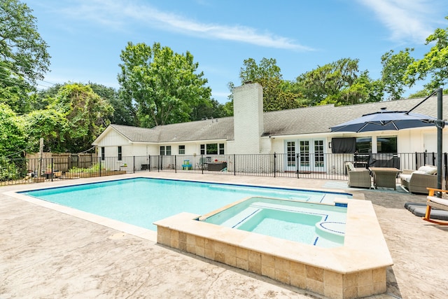 view of swimming pool featuring outdoor lounge area, an in ground hot tub, and a patio area