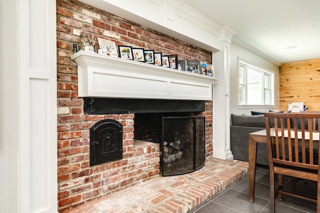 living room featuring a fireplace and dark tile floors