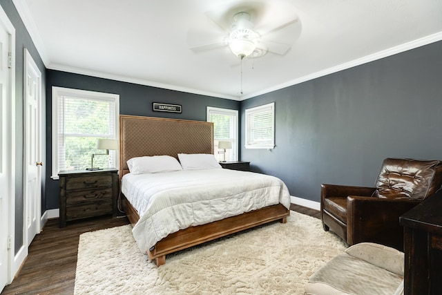 bedroom with crown molding, hardwood / wood-style flooring, and ceiling fan