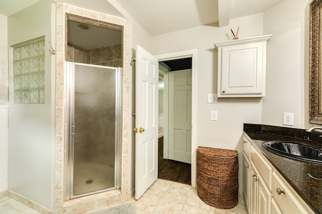 bathroom featuring walk in shower, vanity, and tile floors