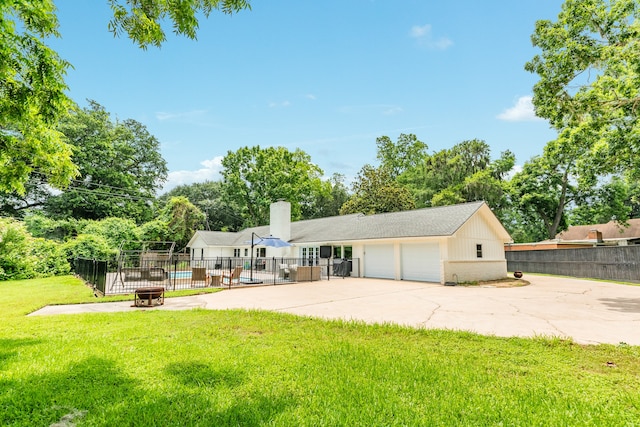 view of front of home featuring an outdoor structure, a garage, and a front lawn