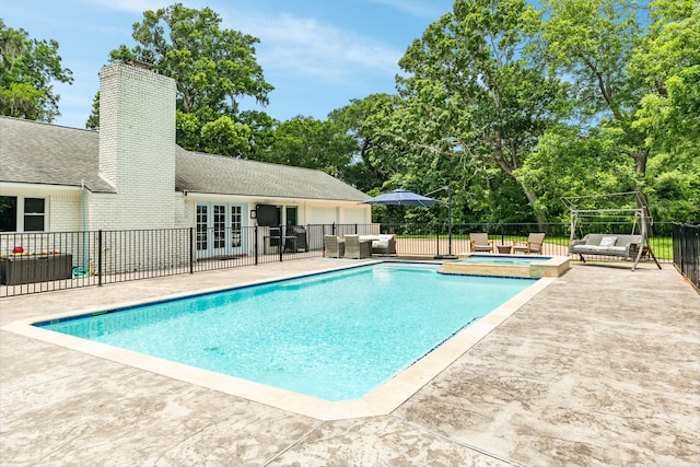 view of pool with french doors, an in ground hot tub, and a patio