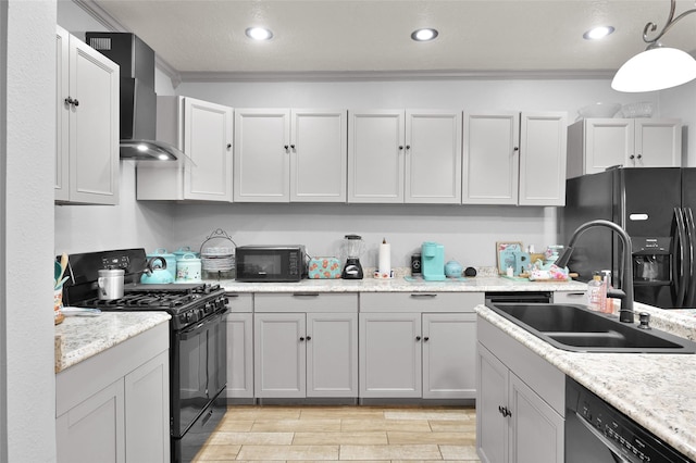 kitchen featuring wall chimney exhaust hood, black appliances, decorative light fixtures, crown molding, and sink