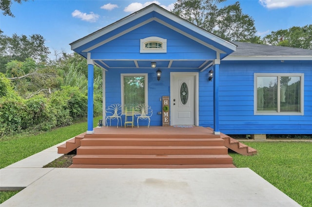 view of front of property with a front yard and a porch