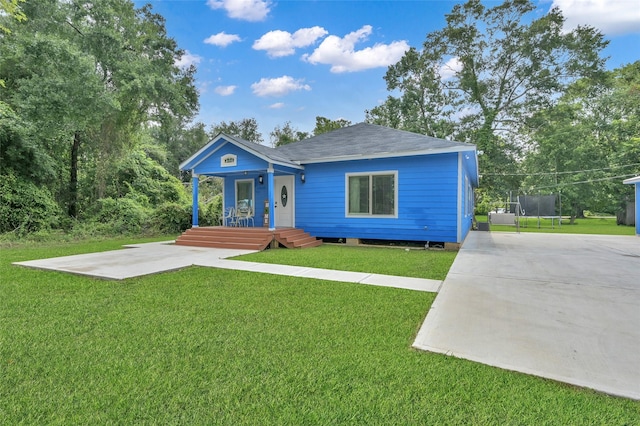 view of front of house featuring a front yard and a trampoline