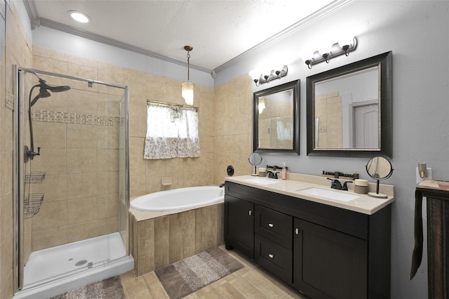 bathroom featuring plus walk in shower, ornamental molding, and vanity