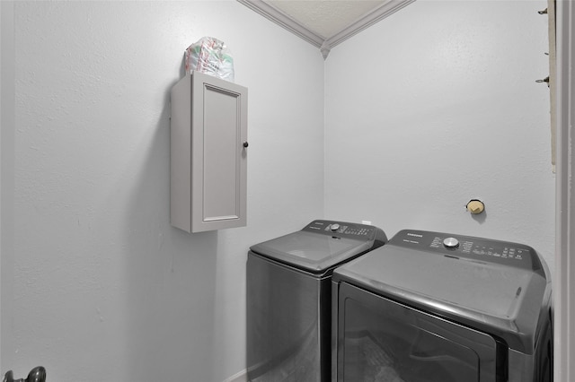 laundry area with separate washer and dryer, ornamental molding, and a textured ceiling