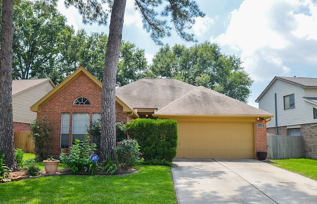 view of front facade with a garage and a front lawn