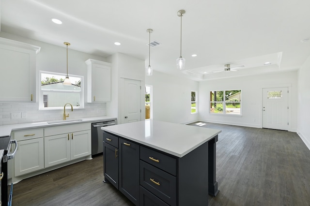 kitchen with a center island, plenty of natural light, ceiling fan, and stainless steel appliances