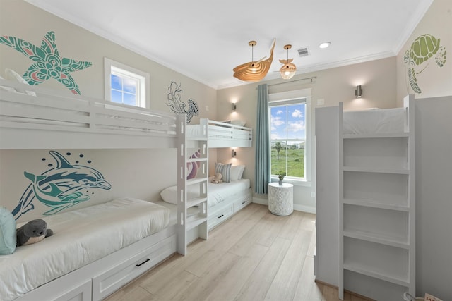 bedroom with light hardwood / wood-style floors, multiple windows, and ornamental molding