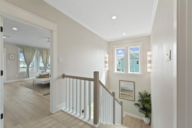 staircase featuring wood-type flooring and ornamental molding