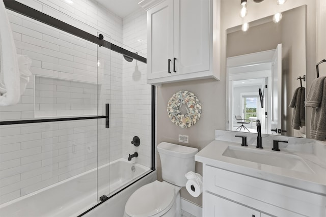 full bathroom with vanity, toilet, and combined bath / shower with glass door