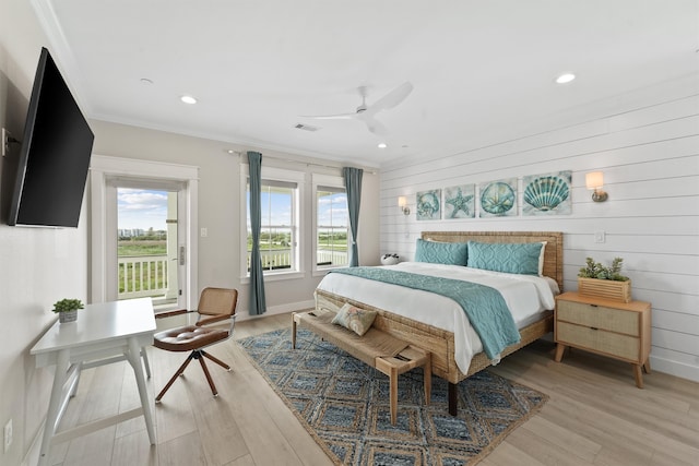 bedroom with ceiling fan, light hardwood / wood-style floors, wood walls, and ornamental molding