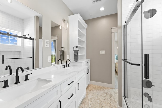 bathroom featuring a shower with door and vanity