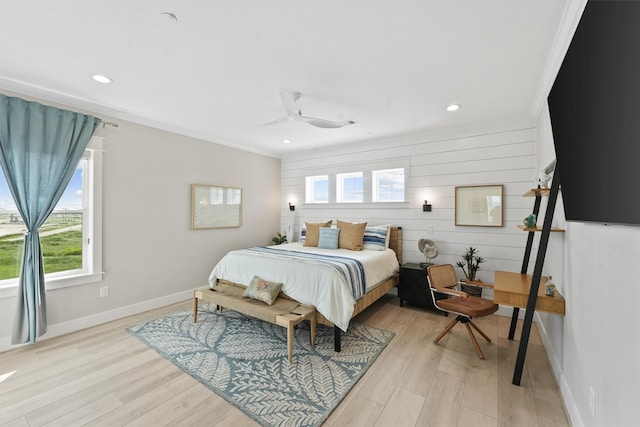 bedroom with light hardwood / wood-style flooring, ceiling fan, and crown molding