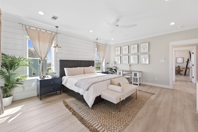 bedroom with ceiling fan, light hardwood / wood-style floors, and crown molding