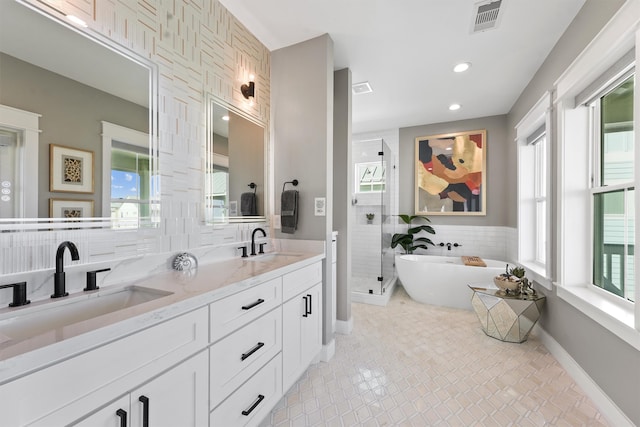 bathroom with plus walk in shower, vanity, and tile patterned floors